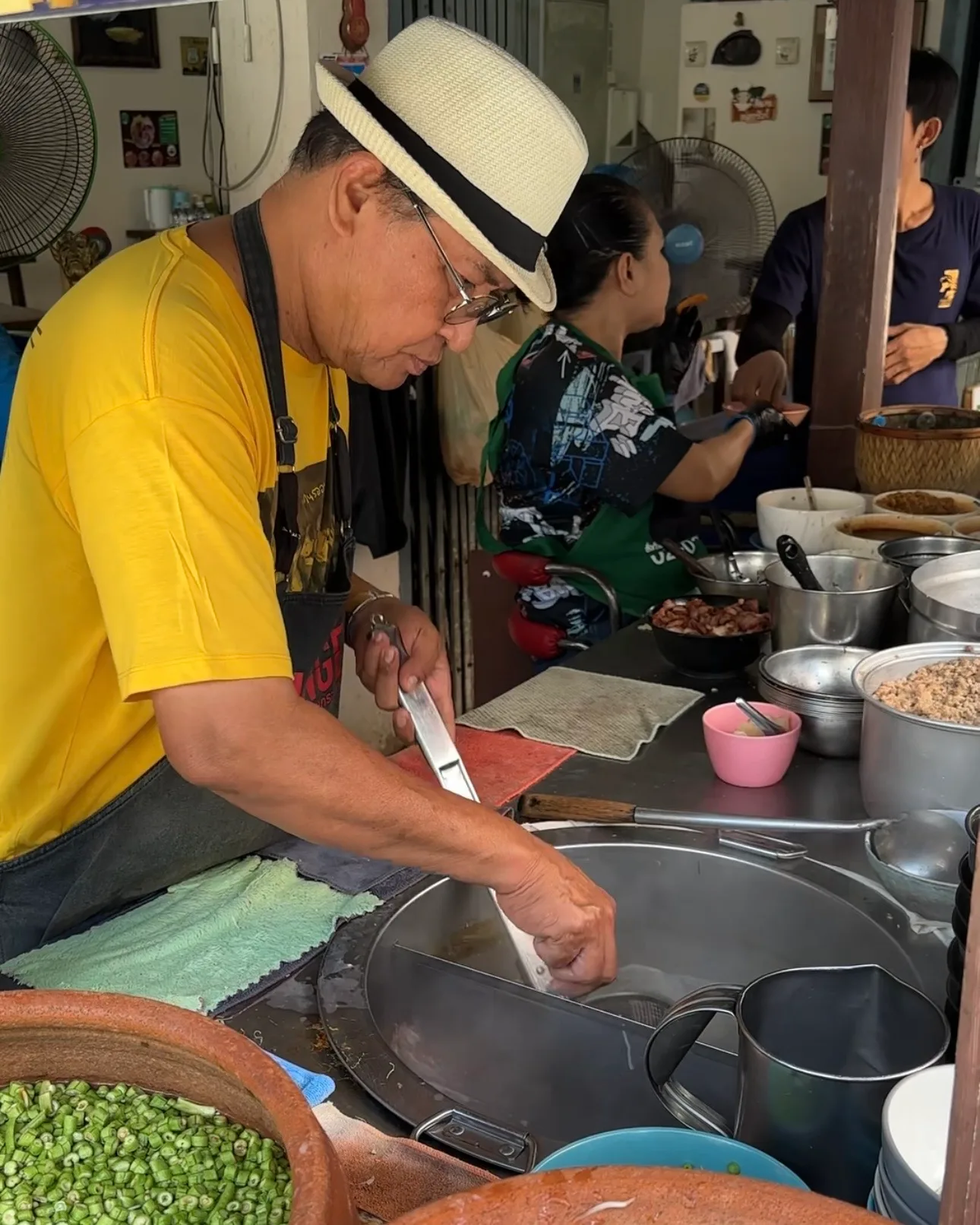 Cook preparing tom yum noodles at Ta Chai Sukhothai Noodles