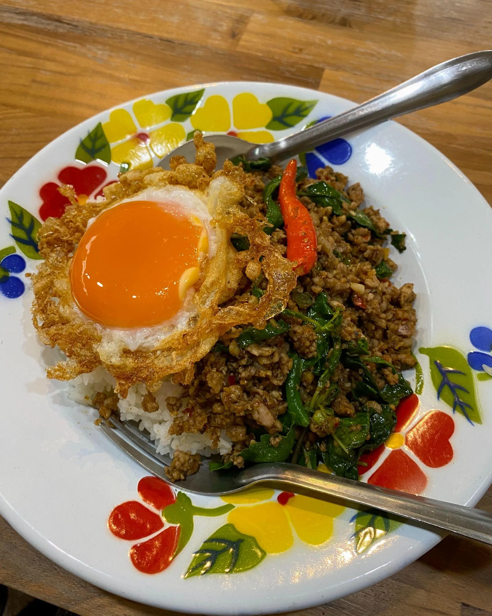 Pad kra pao with crispy fried egg at Phed Mark in Bangkok