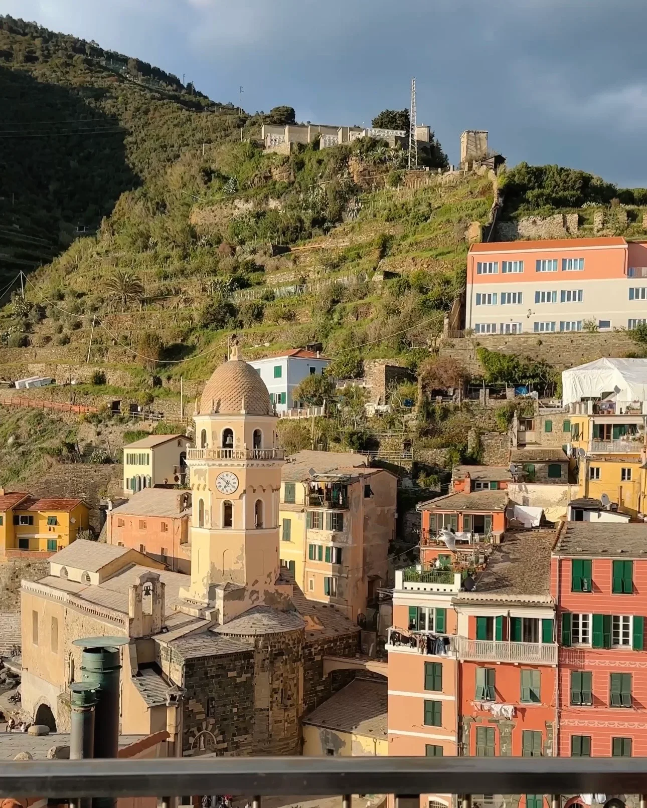 Narrow cobblestone alleyway between colorful buildings in Cinque Terre