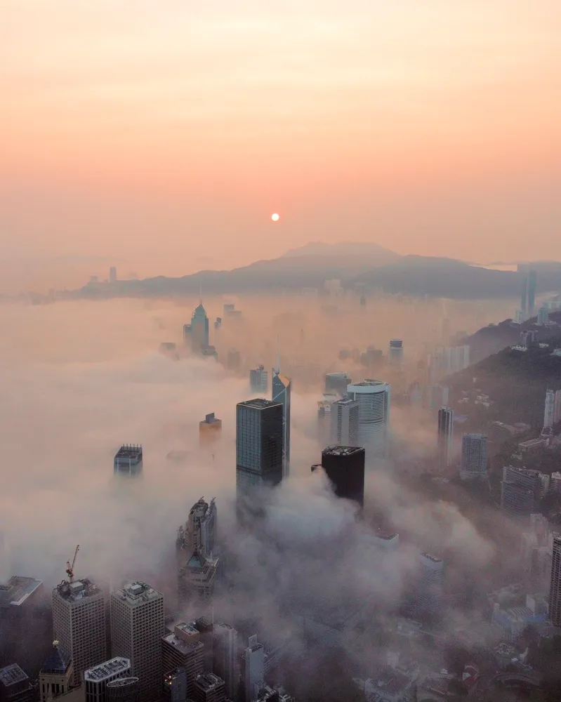 A foggy skyline photo of Hong Kong, drone shot