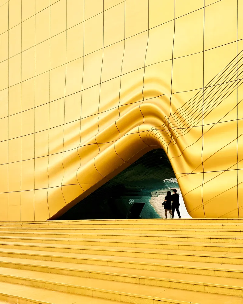 A yellow architectural entrance reminiscent of fabric bunching, South Korea
